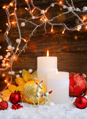 Fototapeta na wymiar Christmas candles with Christmas ornaments and Christmas lights.