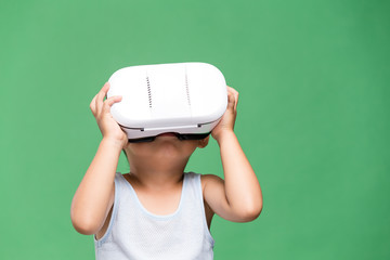 Little boy watching though virtual reality device