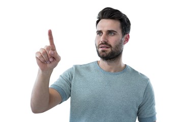 Naklejka premium Man pretending to touch an invisible screen