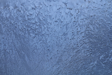 Icy winter patterns on the window in freezing weather