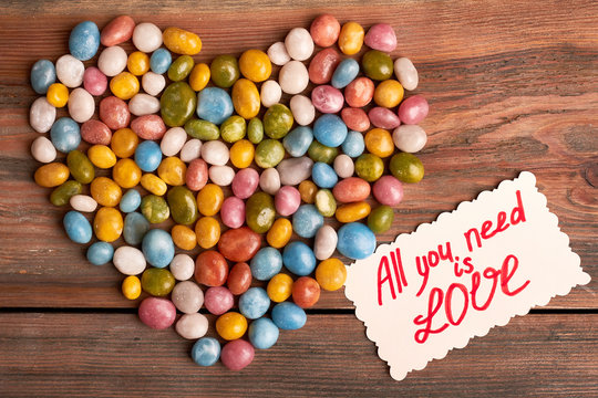 All you need is love. Colorful candy sea pebbles. Sweet romantic surprise.