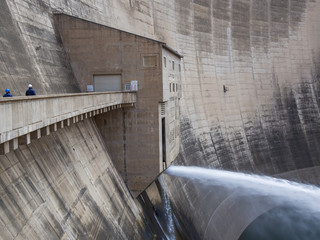 Release of water and two workers at impressive Katse Dam hydroelectric power plant in Lesotho, Africa