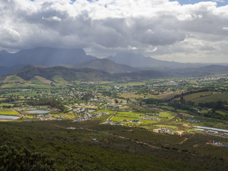 Fototapeta na wymiar Panoramic view over scenic little town Franschoek with dramatic sky