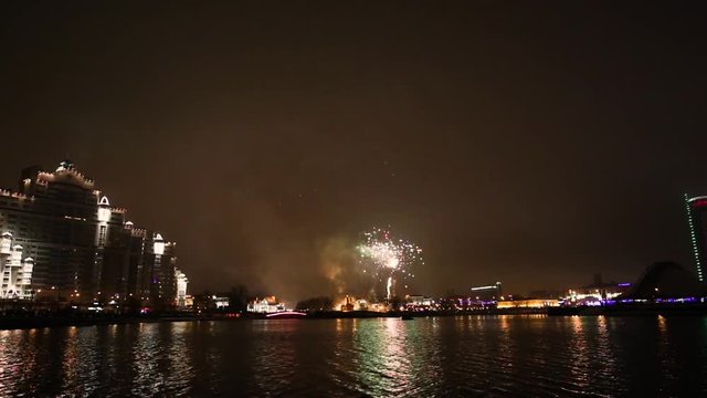 Colorful New Year's fireworks over the river in the center of Minsk. Live action.
