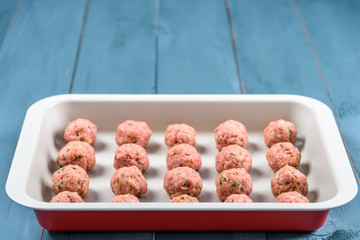 Preparing Raw Meatballs In Pan