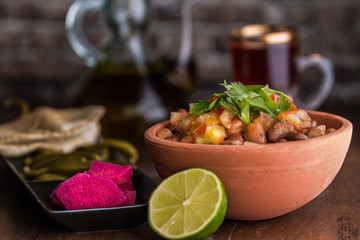 Foul Modammas Fava Beans with Bread, tea, lime and pickles