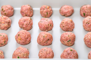 Preparing Raw Meatballs In Pan