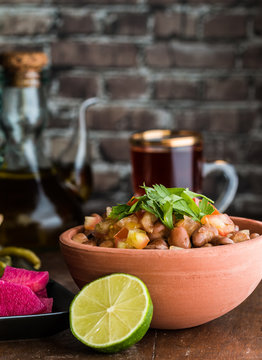 Foul Modammas Fava Beans with Bread, tea, lime and pickles verti
