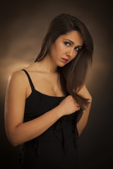 Beauty portrait of young brunette woman . Studio light, yellow background
