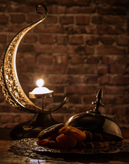 Dried dates, figs and apricots with crescent shaped candle holde