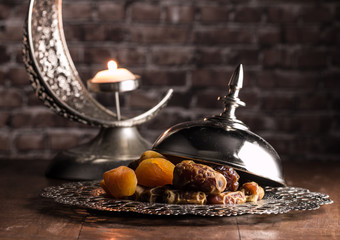 dried dates, figs and apricots with candle holder