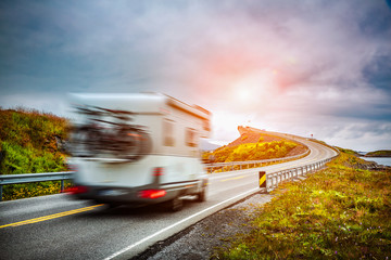 Norway. Caravan car travels on the highway. - obrazy, fototapety, plakaty