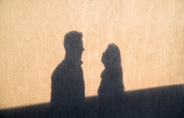 The shadow on the wall of a young loving couple