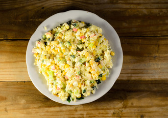 Salad with crab sticks, corn, cucumber, and eggs