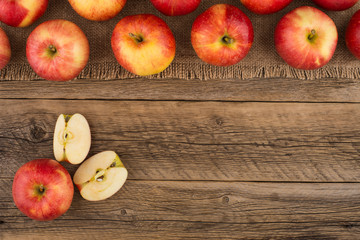 Red apples on the old wooden table.