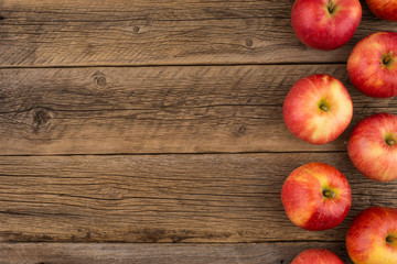Red apples on the old wooden table.