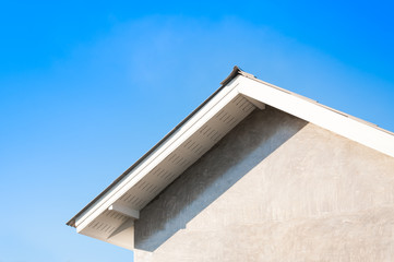 Fototapeta na wymiar House roof whit blue sky,generic view to facade of a new house with blue sky in background