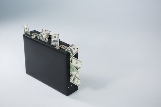 Bank notes coming out of briefcase