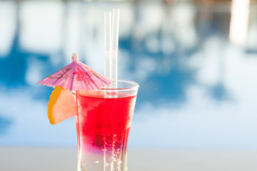 Colored cocktails on a background of water. Colorful cocktails near the pool. Beach party. Summer...