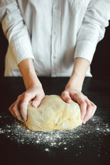 hands knead the dough