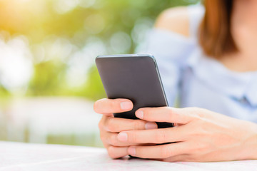 Woman hands holding smart phone.