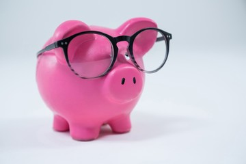 Close-up of piggy bank with spectacles