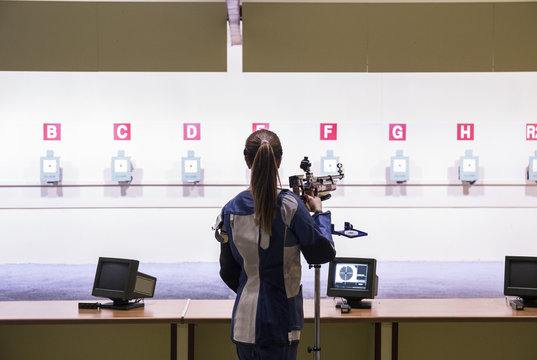 Woman in front of the targets in a shooting range