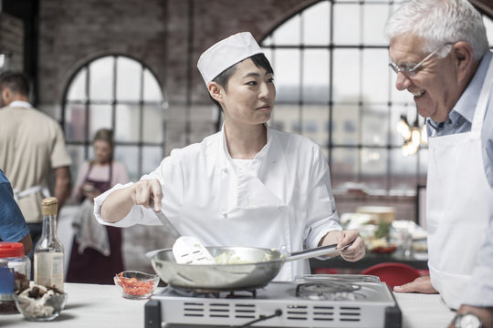 Senior man taking a cooking course