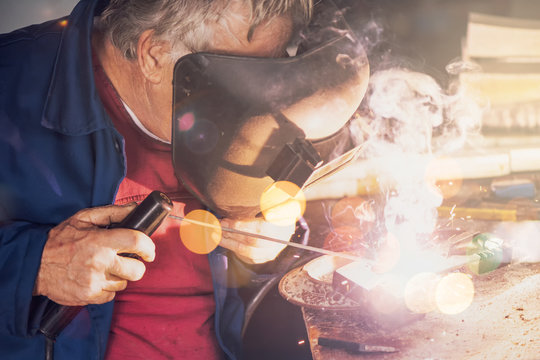 Welder welding in workshop