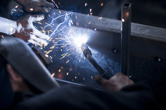 Close-up of two welders at work