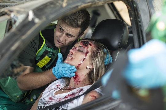Paramedics helping car crash victim after accident