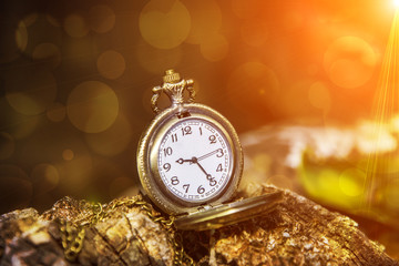 watch locket on the wooden table bokeh background and flare