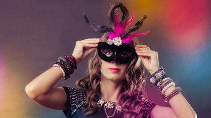 Woman with carnival venetian mask on dark