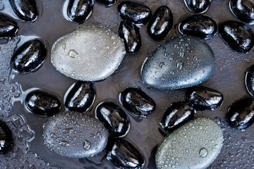 Naklejki  spa concept/massage stones on slate with water drops top view
