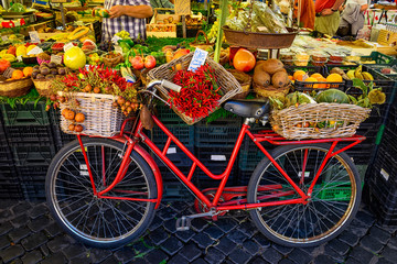 Naklejka premium Czerwony stary rower na rynku na Campo di Fiori, Rzym, Włochy