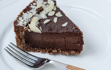 Chocolate raw vegan cake with nuts, figs and carob. Love for a healthy raw food concept.