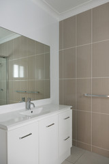 New modern bathroom with vanity and tiled wall