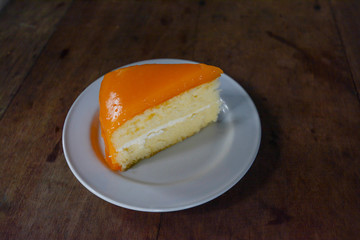 Orange cake on wooden background
