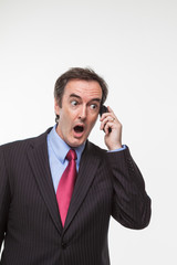 Fototapeta premium Surprised businessman on cell phone