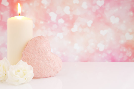 Valentine's heart and candle with a bright background
