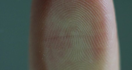 fingerprint leaning on control glass for biometric scan. concept of surveillance and security through human fingerprints in the future of digital technology. (macro close up) - Powered by Adobe