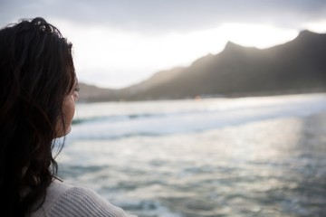 Fototapeta premium Thoughtful woman standing on beach