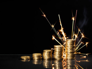 Euro coin stack with firework in background. Financial target is achieved - time for celebration