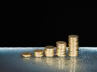 Fresh money coin stack with waterdrops.