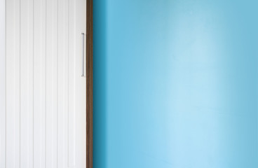 white and wood wardrobe in blue wall empty bedroom