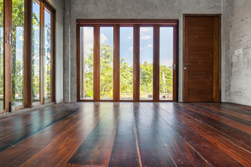 Folding doors with tall windows old wooden floor in empty living room interior