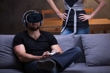 Gamer with VR goggles and angry girlfriend