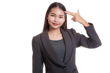 Beautiful young Asian woman holding fingers in gun gesture.