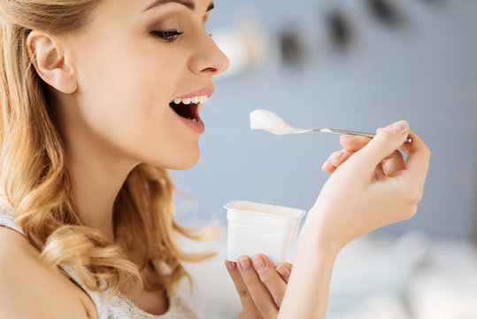 Portrait of pregnant woman eating yoghurt