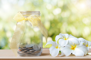 glass piggy bank with sunset light in saving money concept and f